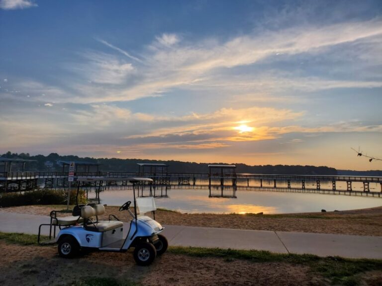 Golf cart near a waterbody at sunset time